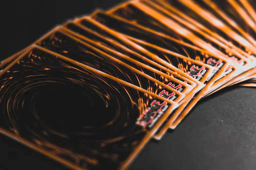 Close-up glossy foil trading cards on a dark table